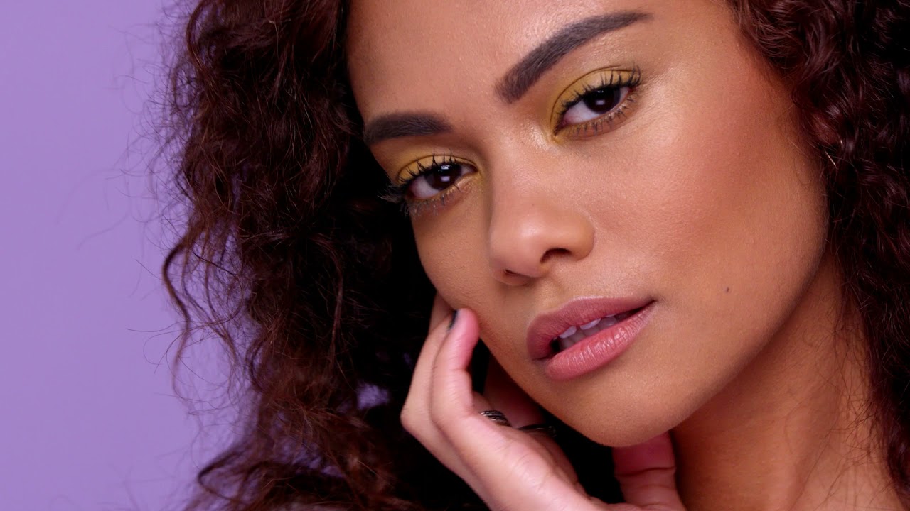 Setting spray bottles against a summer travel background.